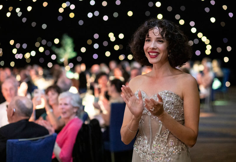 Women in silver dress clapping Women in silver dress clapping