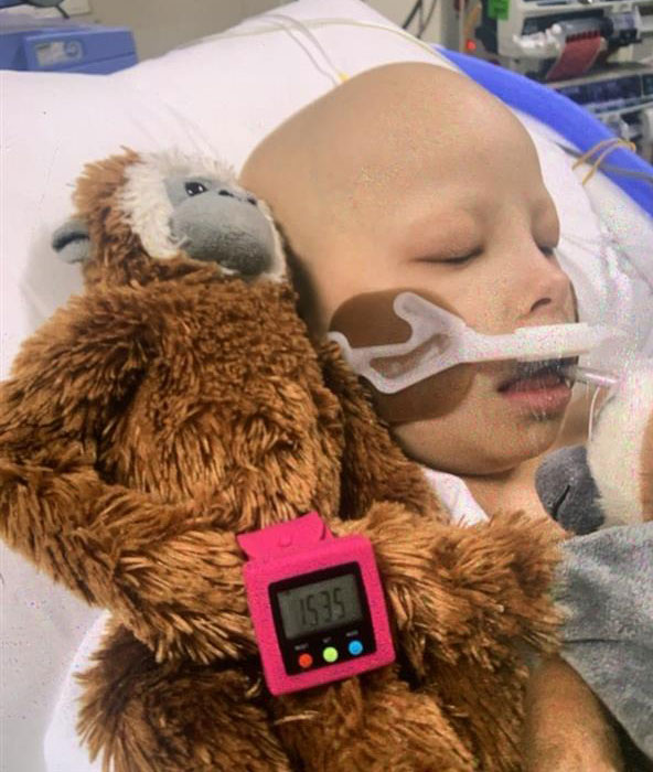 Matilda in hospital with her toy monkey